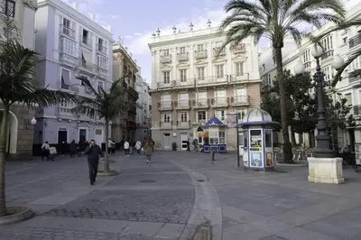 a city street with palm trees and buildings at GuestReady - La Merced Cadiz in Cádiz