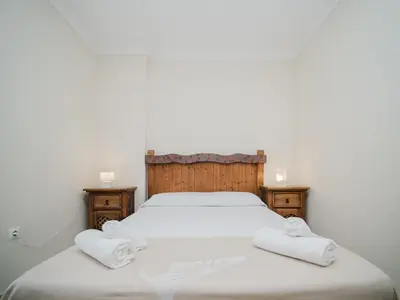 a bedroom with a bed with two towels on it at La casa del Ceramista in Sanlúcar de Barrameda