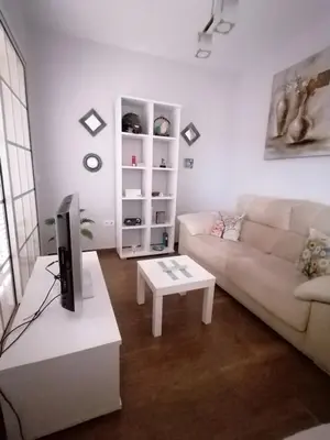 a living room with a couch and a table at Vivienda en Jerez de la Frontera in Jerez de la Frontera