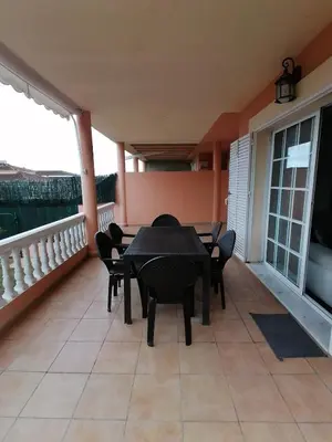 a patio with a table and chairs on a balcony at Vivienda en Jerez de la Frontera in Jerez de la Frontera
