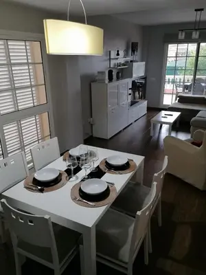 a dining room and kitchen with a white table and chairs at Vivienda en Jerez de la Frontera in Jerez de la Frontera
