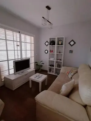 a living room with a couch and a flat screen tv at Vivienda en Jerez de la Frontera in Jerez de la Frontera