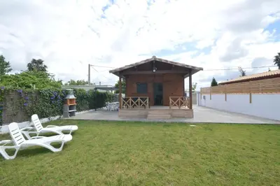 a backyard with two chairs and a small building at Villa Farom in Cádiz