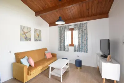 a living room with a couch and a tv at Villa Farom in Cádiz
