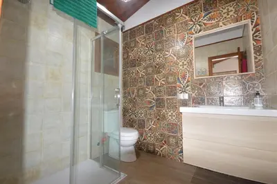 a bathroom with a toilet and a sink and a mirror at Villa Farom in Cádiz