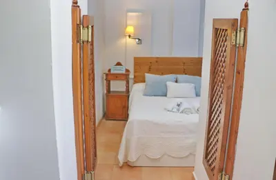 a bedroom with a bed with a wooden frame at Apartamento con vistas Bahia Sur in San Fernando