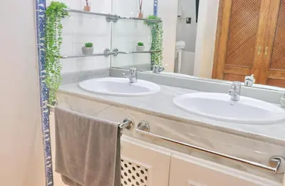 a bathroom with two sinks and a mirror at Apartamento con vistas Bahia Sur in San Fernando