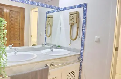 a bathroom with two sinks and a mirror at Apartamento con vistas Bahia Sur in San Fernando