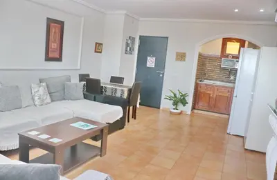 a living room with a couch and a table at Apartamento con vistas Bahia Sur in San Fernando