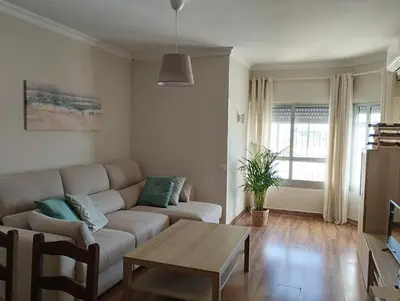 a living room with a couch and a table at Virgen de los Milagros in El Puerto de Santa María