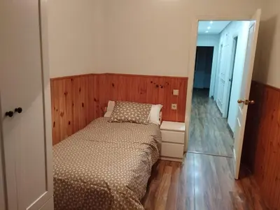 a small bedroom with a bed and a mirror at Virgen de los Milagros in El Puerto de Santa María