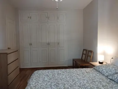 a bedroom with a bed and a desk and a chair at Virgen de los Milagros in El Puerto de Santa María