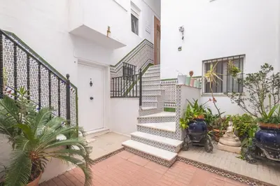 a hallway of a house with stairs and plants at Casa dSanz 