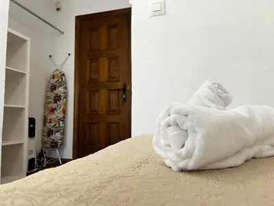 a pile of towels sitting on top of a bed at CasaLola in Sanlúcar de Barrameda