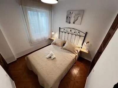 a bedroom with a bed with two towels on it at CasaLola in Sanlúcar de Barrameda