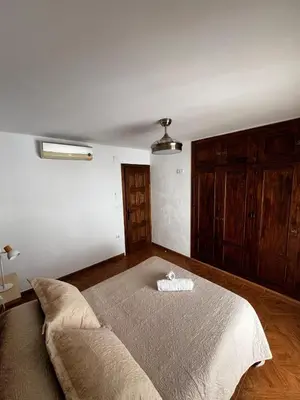 a bedroom with a bed and a couch in it at CasaLola in Sanlúcar de Barrameda