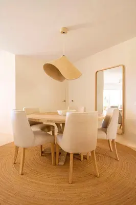 a dining room with a table and chairs and a mirror at Apto Lujo Exclusivo vistas Golf y Mar in Novo Sancti Petri