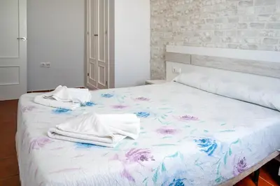 a bedroom with a bed with towels on it at Casas Rurales Pericón in Conil de la Frontera