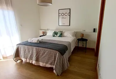 a bedroom with a bed with a blanket on it at El Ático de la Angelita by RentCadiz in El Puerto de Santa María