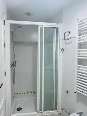 a shower with a glass door in a bathroom at La Casita Gaditana Centro in Cádiz