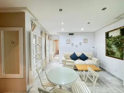 a living room with a table and a couch at La Casita Gaditana in Cádiz