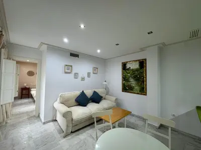 a living room with a couch and a table at La Casita Gaditana in Cádiz