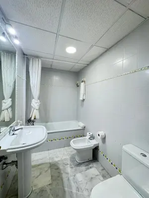 a bathroom with a sink and a toilet and a tub at La Casita Gaditana in Cádiz