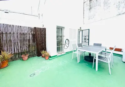 a patio with a table and chairs on a balcony at La Casita Gaditana in Cádiz