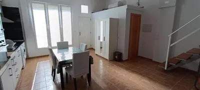 a dining room with a table and some chairs at Apartamento VILLASUR in Alcalá de los Gazules