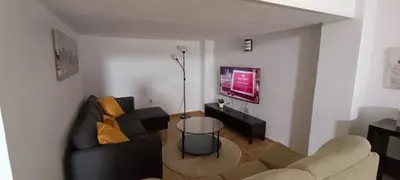 a living room with a couch and a table at Apartamento VILLASUR in Alcalá de los Gazules