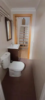 a bathroom with a toilet and a sink at Apartamento VILLASUR in Alcalá de los Gazules
