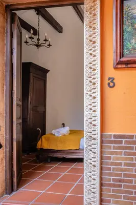 a bedroom with a bed in the corner of a room at La Posada de Zepeda in Jerez de la Frontera