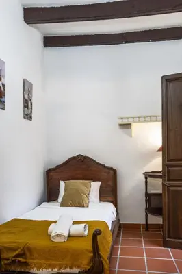 a bedroom with a bed with two towels on it at La Posada de Zepeda in Jerez de la Frontera