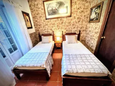 two beds sitting in a room with at La Posada de Zepeda in Jerez de la Frontera
