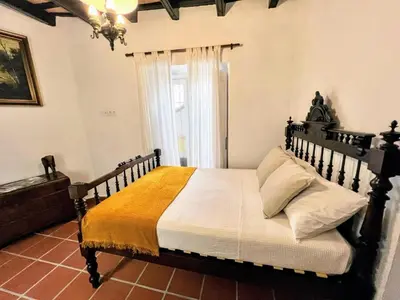 a bedroom with a wooden bed and a window at La Posada de Zepeda in Jerez de la Frontera
