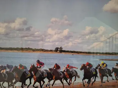 a group of people riding horses on the beach at Plaza Doctor Barbadillo in Sanlúcar de Barrameda
