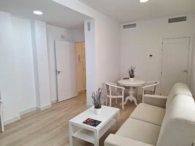 a living room with a couch and a table at Plaza Doctor Barbadillo in Sanlúcar de Barrameda