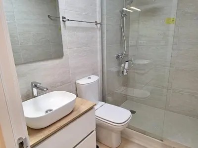 a bathroom with a toilet and a sink and a shower at Plaza Doctor Barbadillo in Sanlúcar de Barrameda