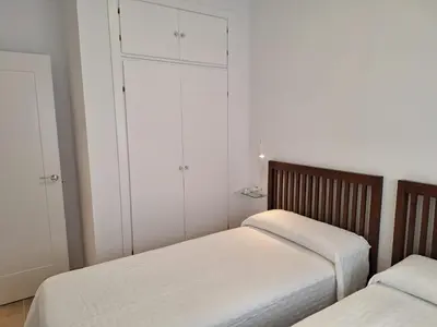 a bedroom with two beds and a closet at Plaza Doctor Barbadillo in Sanlúcar de Barrameda