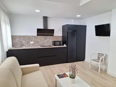 a kitchen with a couch and a counter top at Plaza Doctor Barbadillo in Sanlúcar de Barrameda