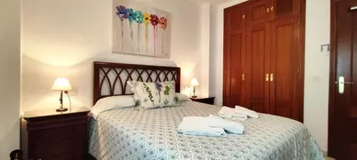 a bedroom with a bed with two towels on it at Apartamento Cabo Noval in Sanlúcar de Barrameda