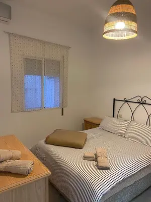 a bedroom with a bed with two towels on it at Casa Alzar2 in Jerez de la Frontera
