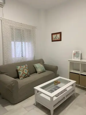 a living room with a couch and a coffee table at Casa Alzar2 in Jerez de la Frontera
