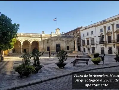 a building with a courtyard with a bench in front of it at Casa Alzar2 in Jerez de la Frontera