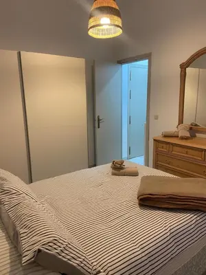 a bedroom with a large bed and a mirror at Casa Alzar2 in Jerez de la Frontera