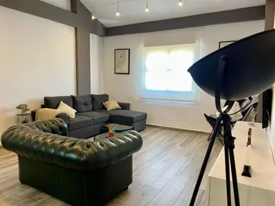 a living room with a couch and a camera at Paradise Vista in Poblado de Sancti Petri