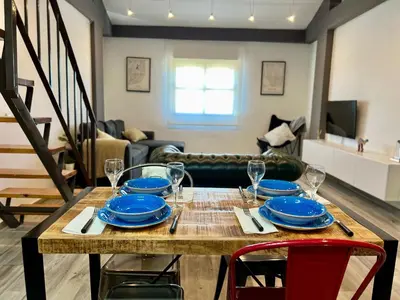 a dining room table with plates and wine glasses on it at Paradise Vista in Poblado de Sancti Petri
