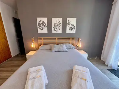 a bedroom with a large bed with two towels on it at Paradise Vista in Poblado de Sancti Petri