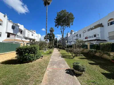 a sidewalk in a yard with trees and buildings at Paradise Vista in Poblado de Sancti Petri