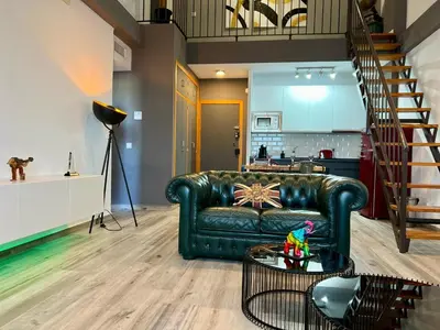 a living room with a leather couch and a table at Paradise Vista in Poblado de Sancti Petri